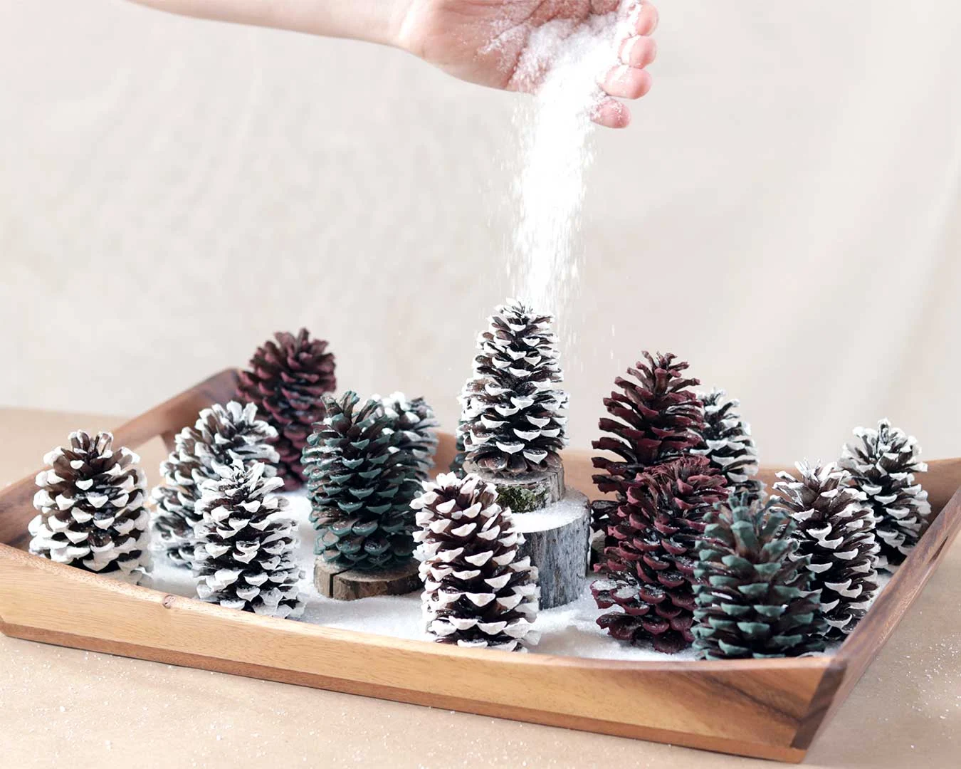 decorating Christmas pinecones with glitter