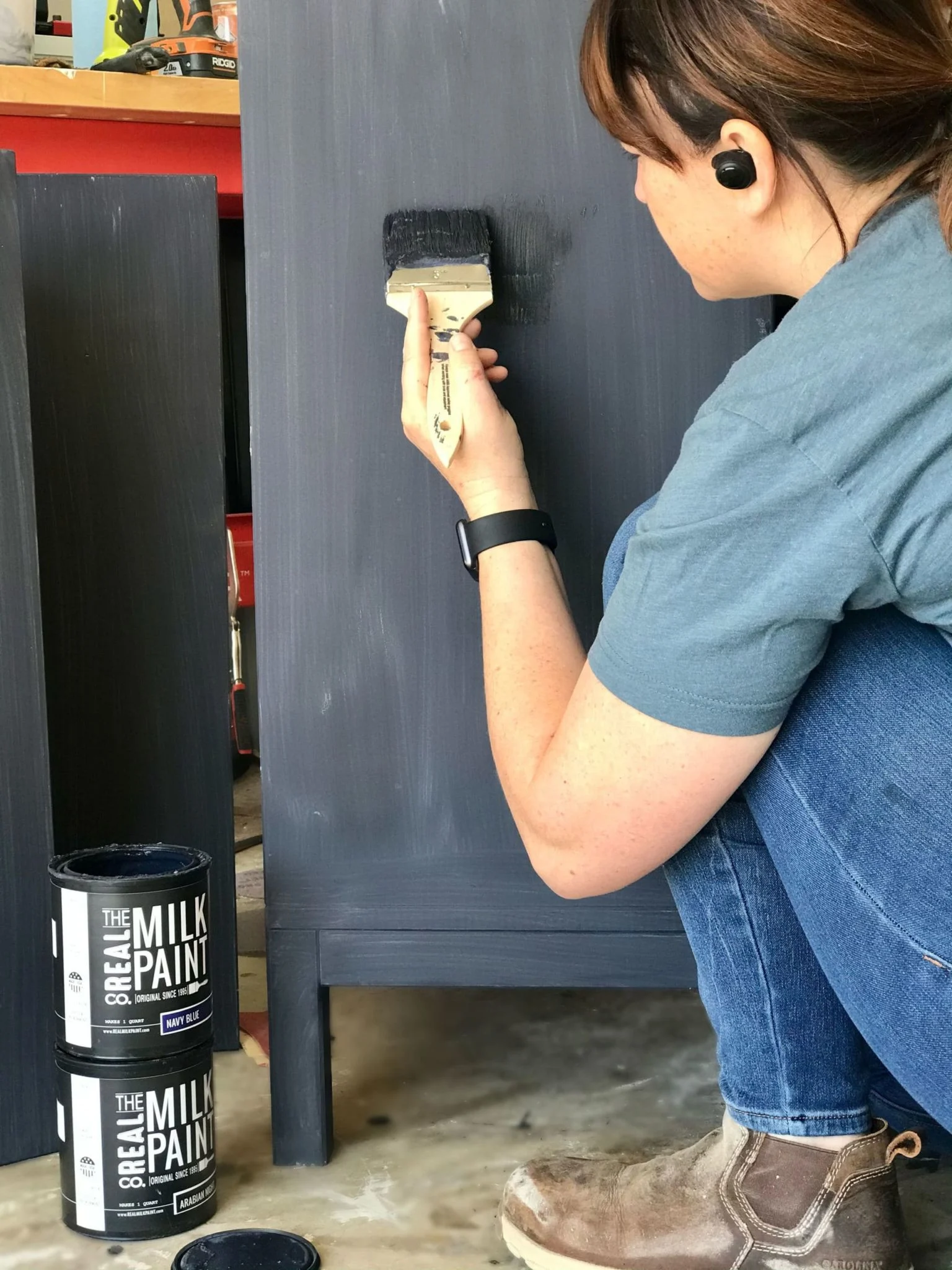 Woman applying paint with paintbrush