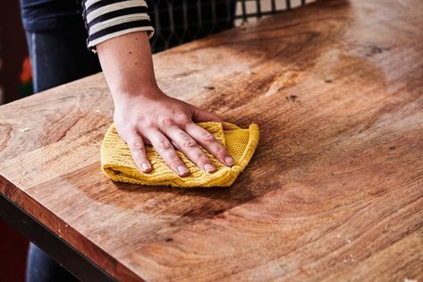 cleaning the wood furniture with a damp cloth cleaning the wood furniture with a damp cloth