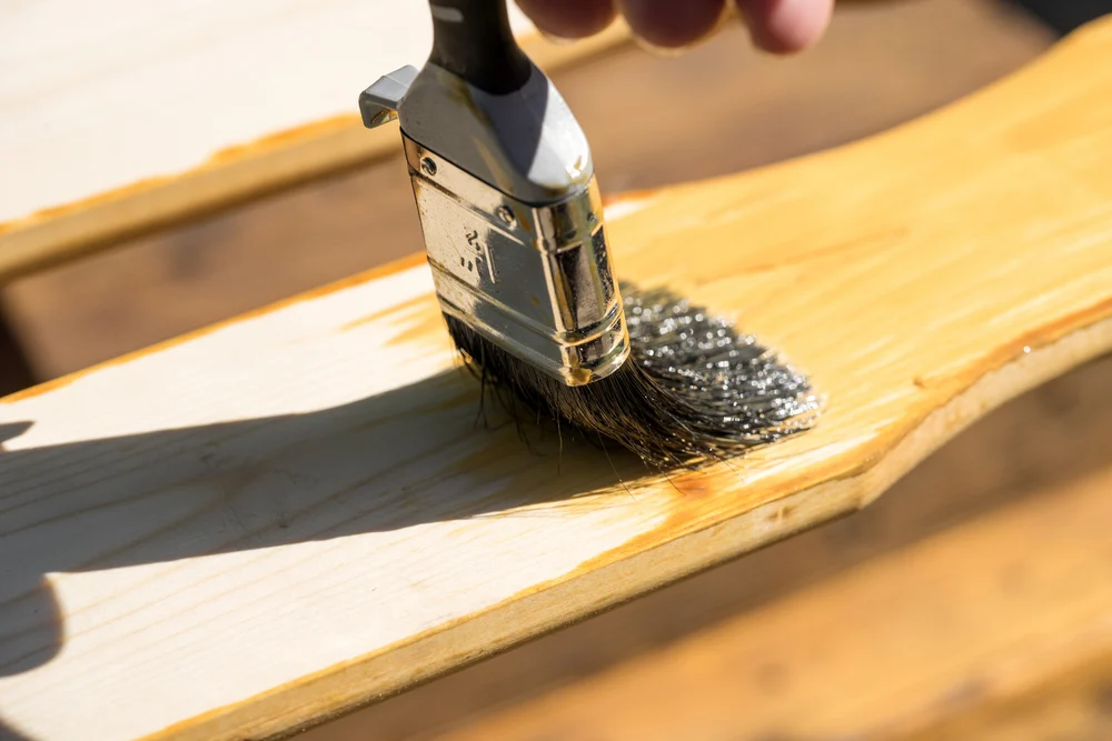 real milk paint finishing oil for wood finishes being used on wood furniture