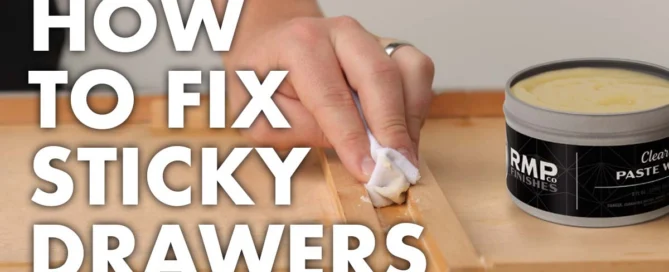Image of hand applying RMP Finishes Paste Wax to wooden drawer bottom.