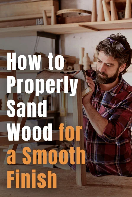 man sanding a wooden chair frame