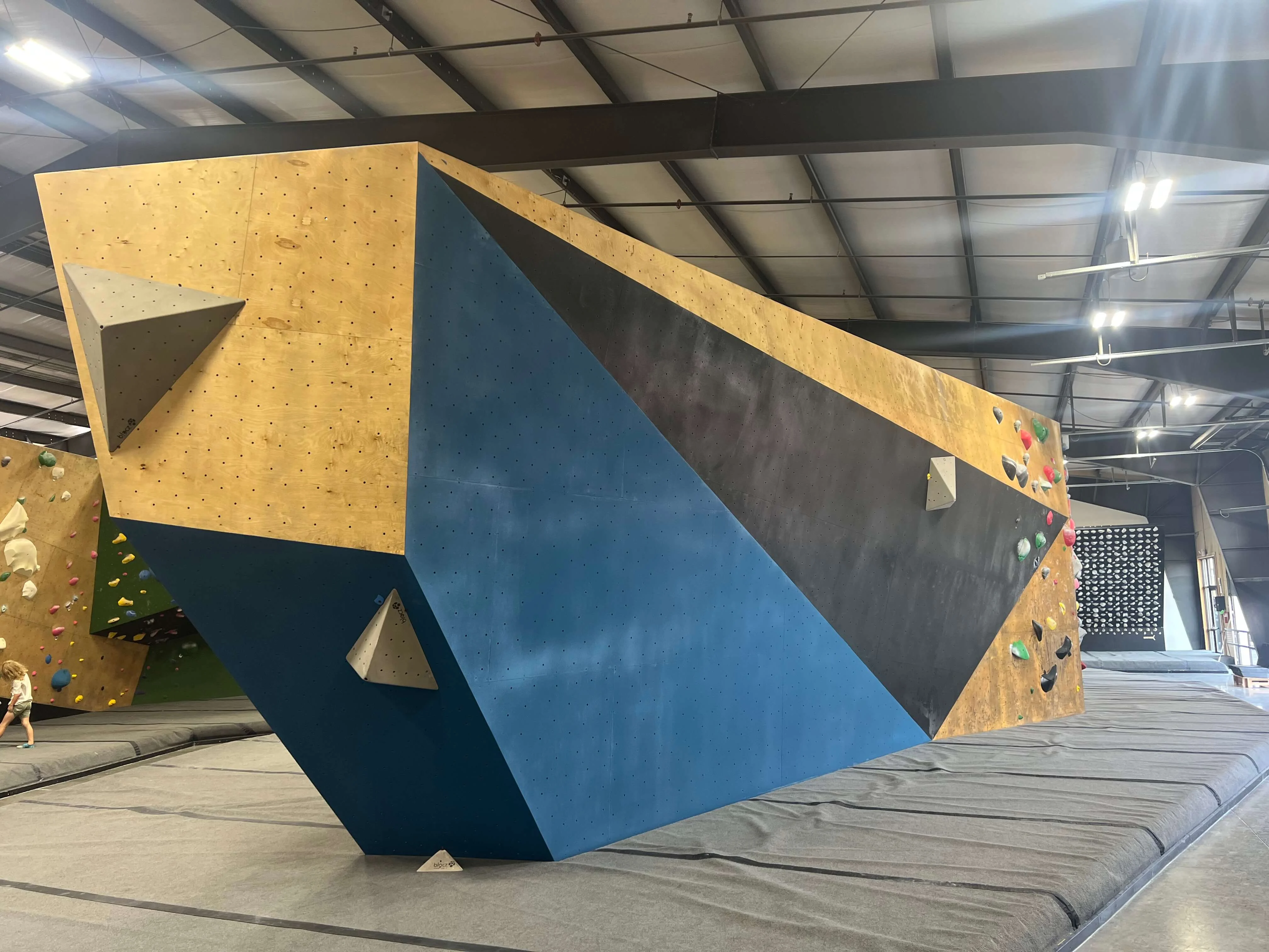 Bright, freshly textured sections of the Circuit Gym climbing walls showing updated, highly opaque colors.