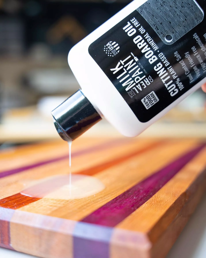 Applying cutting board oil on wood surface, showing difference in protection for cutting board wax vs oil