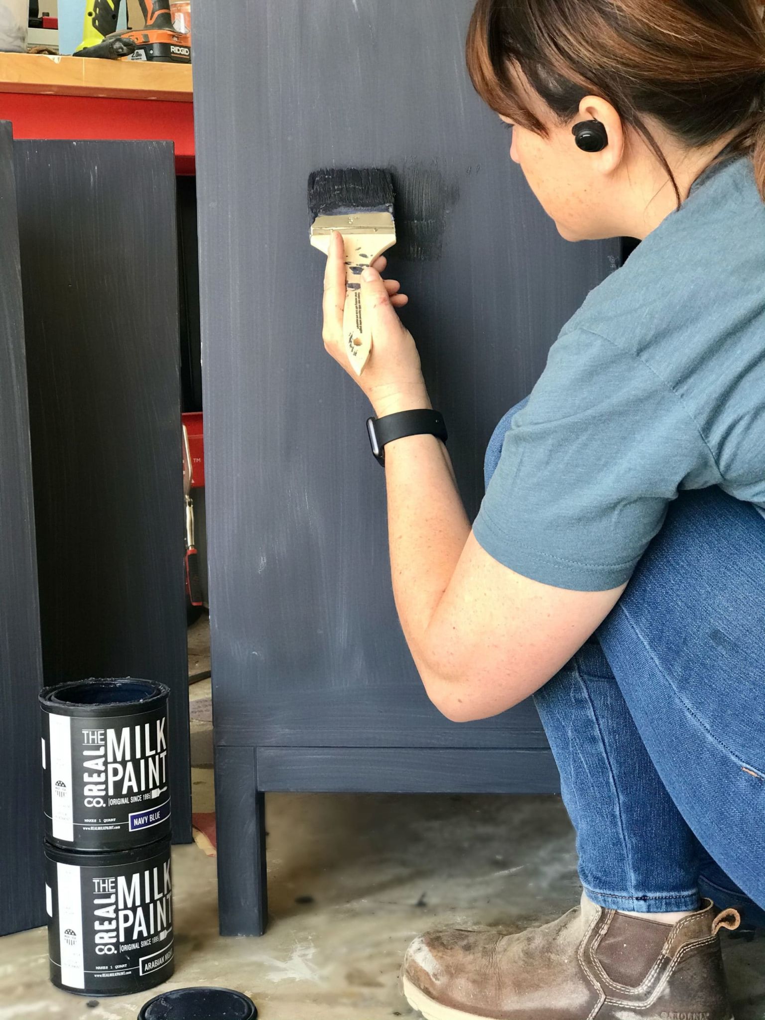 Woman applying paint with paintbrush