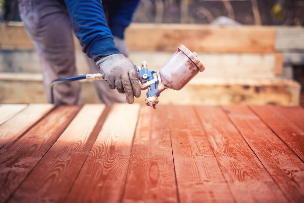 guy start painting with air spray gun guy start painting with air spray gun