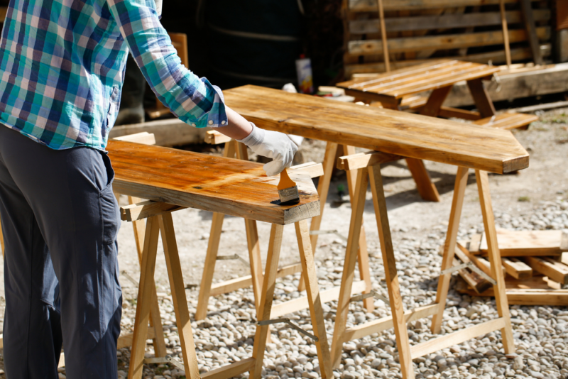 man applying wood finishing oil
