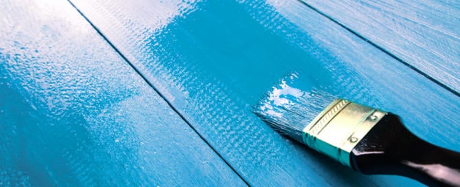 Painting a wooden shelf using paintbrush